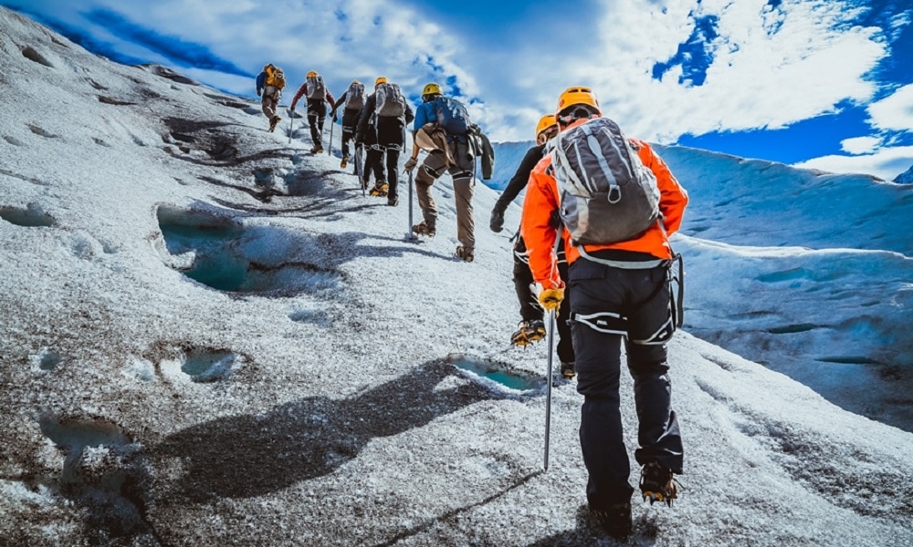 Line of hikers on rock slope in Patagonia