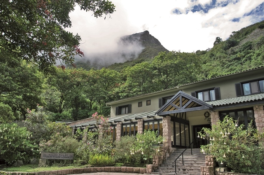 Belmond Sanctuary Lodge, Front, surrounded by lush green vegetation