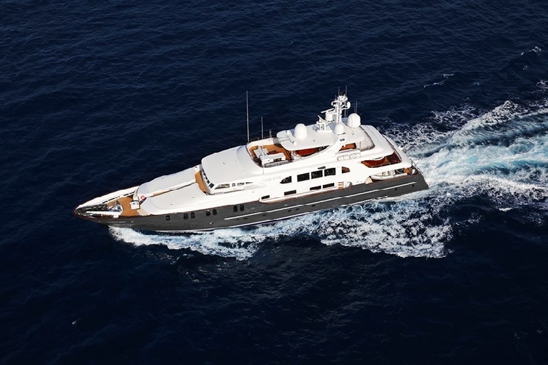 Sleek yacht cruising in the open icean - photo from above.