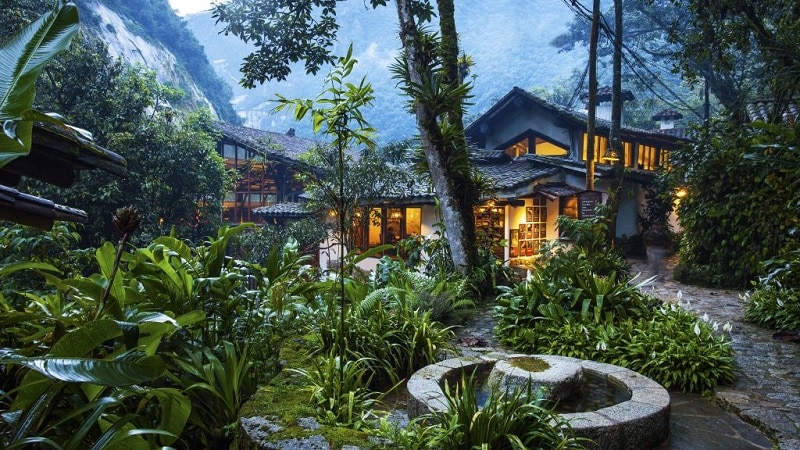 Hotel at dusk in misty jungle setting