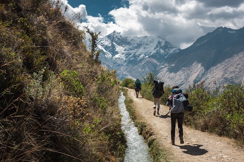 Several trekkers high in the Andes with the Salkantay Mountain in the background.