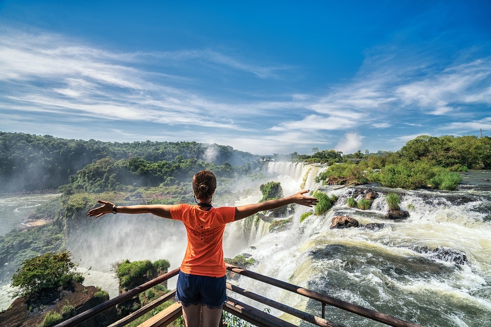 Lady enjoying the power of Iguazu Falls at Lookout point.